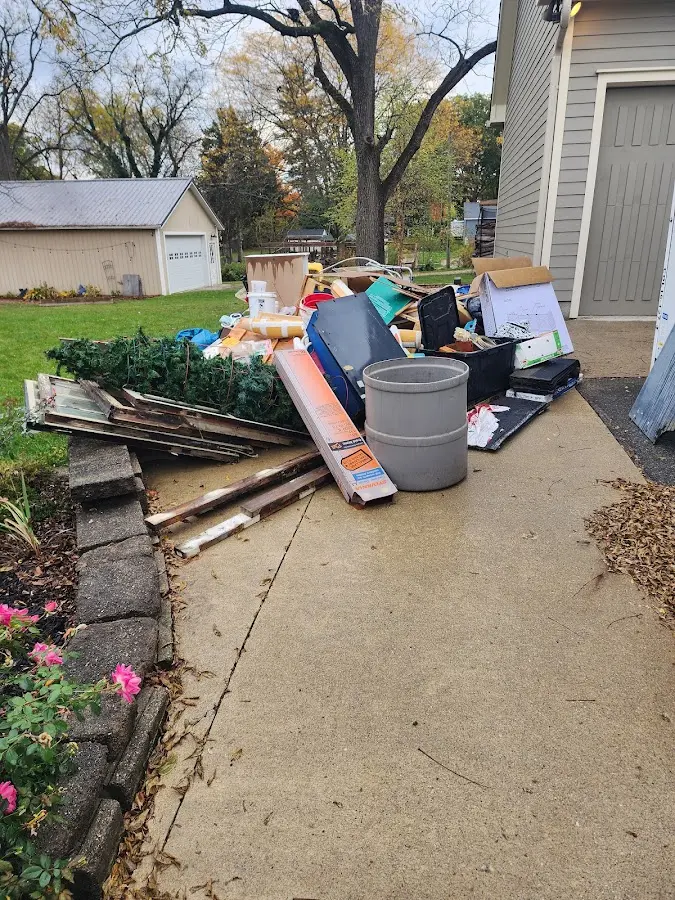 Dumpster being loaded with debris for Roofing Dumpster Rental in Egelston